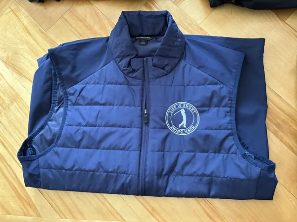 Navy quilted vest with an embroidered golf logo on the chest