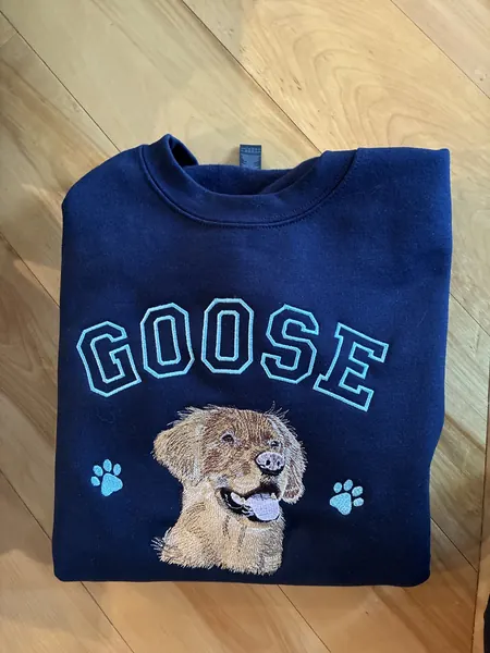 Navy GOOSE sweatshirt with an embroidered portrait of a golden dog