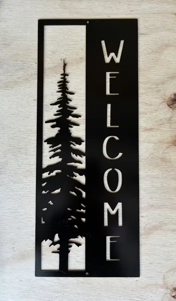 Black vertical steel WELCOME sign with a pine tree cutout
